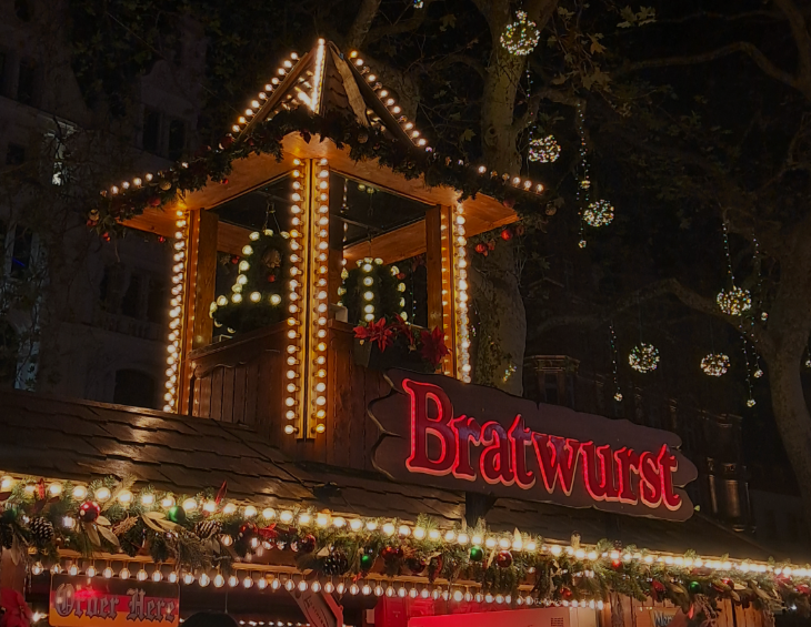 Self-guided Christmas lights walking route London 2025: a Bratwurst stall at the Leicester Square Christmas market