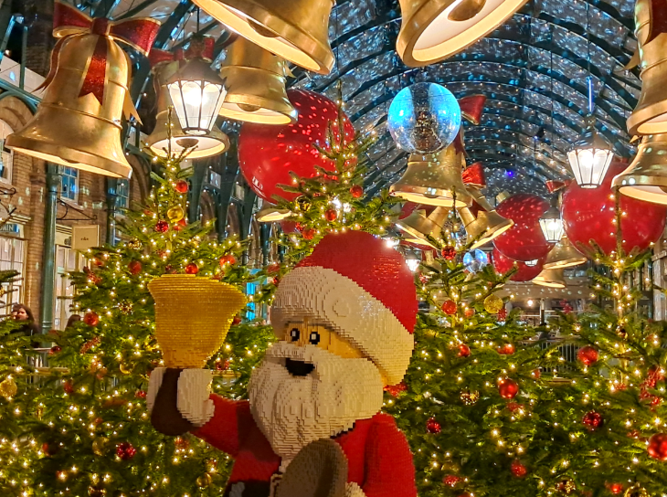 Self-guided Christmas lights walking route London 2025: Lego Santa in front of the baubles and bells of Covent Garden