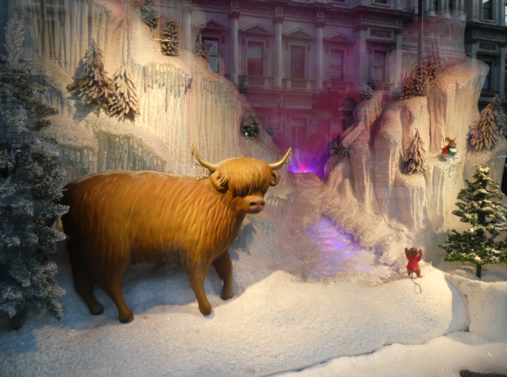 Self-guided Christmas lights walk London 2025: a highland cow in a snowy scene in the Fortnum & Mason Christmas window display