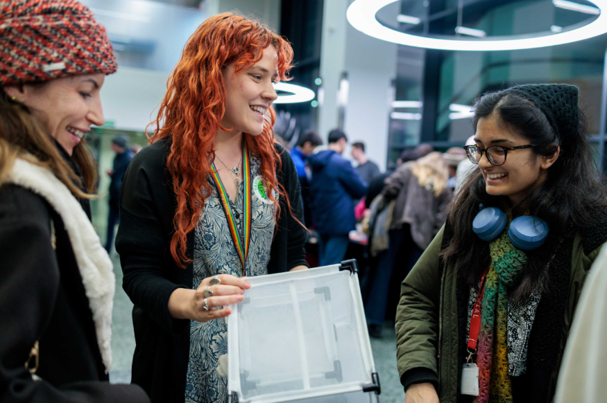 Free events in London: three young people, standing in a group chatting at Imperial Lates