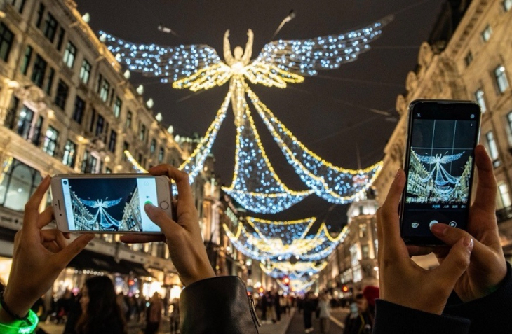 Free events in London: people taking photos of the Regent Street Christmas lights