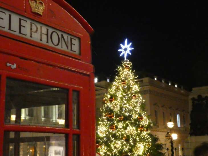 Self-guided Christmas lights walk London 2025: a glowing Christmas tree behind a red telephone box