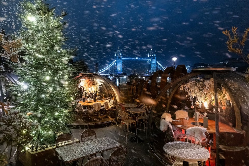 Igloos in the snow, with Tower Bridge in the background