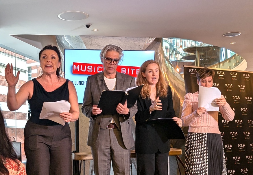 A cast rehearsing a music