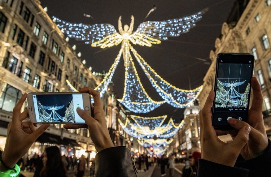 People snapping the Christmas lights on Regent Street