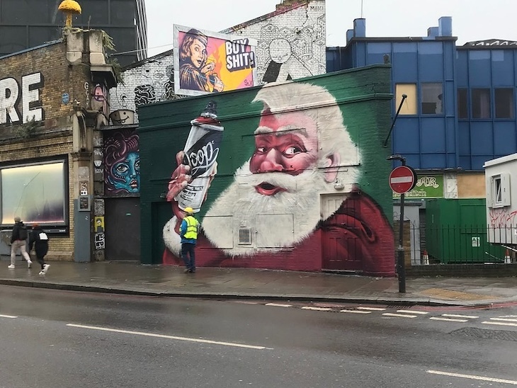 Santa with a spray can at village underground in shoreditch