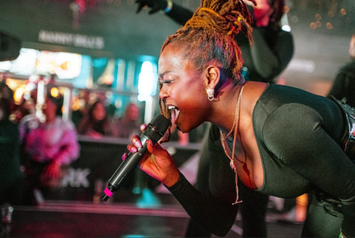 What's on in London today: a performer singing into a mic on stage