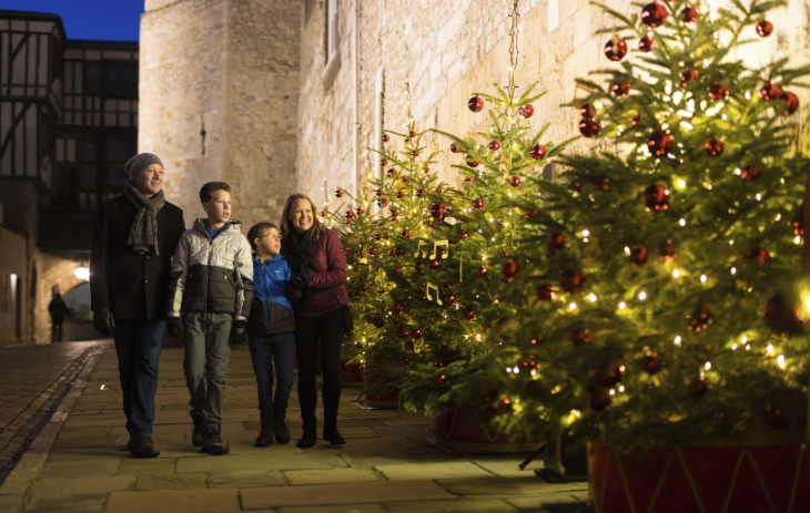 Things to do in London today:  a family admiring Christmas trees at the Tower of London