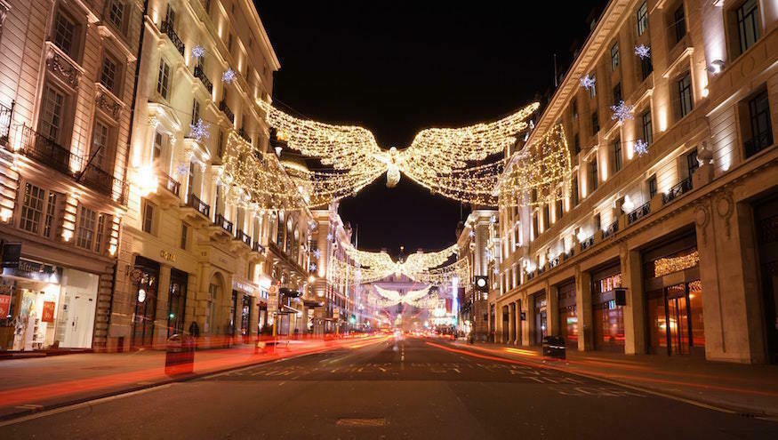Things to do in London on Christmas Day 2025: angel Christmas lights above a deserted street 