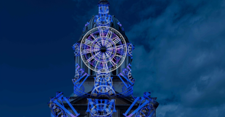 Things to do in London this weekend: a clock projected onto a tower at the Old Royal Naval College