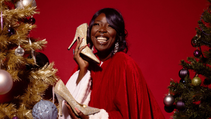 What's on in London today: a woman in a red cloak holding glittery shows, alongside Christmas trees