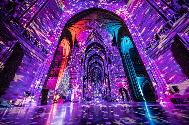 Things to do in London today:  the interior of a cathedral illuminated in purple with stars