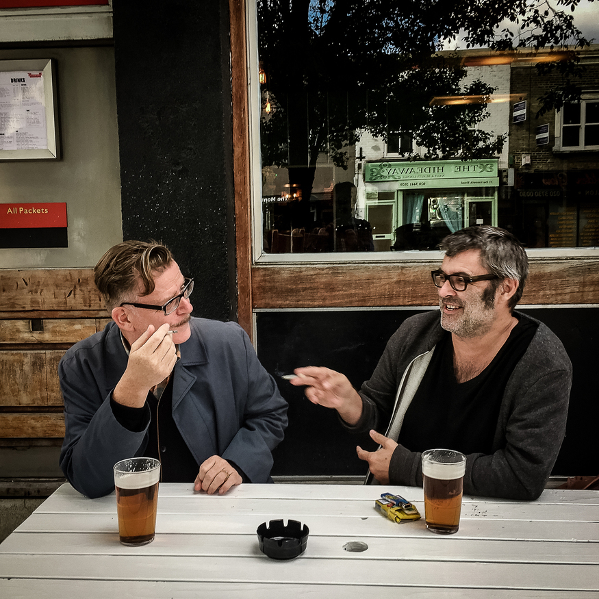 Two men having a beer and a fag