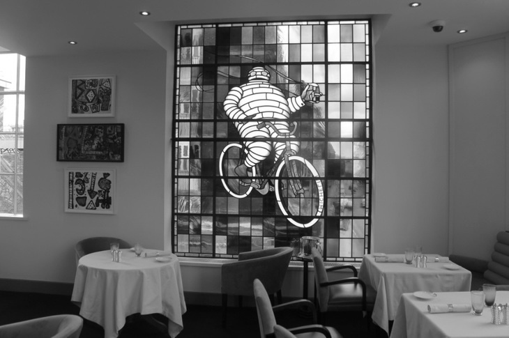 A restauarant with Bibendum themed stained glass