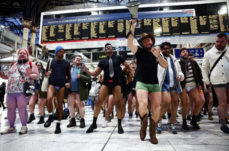 London no trousers tube ride 2026: a crowd of people without their trousers on the concourse at Liverpool Street