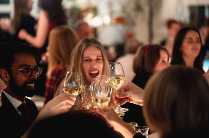 Best New Year's Eve parties in London: people clinking champagne glasses