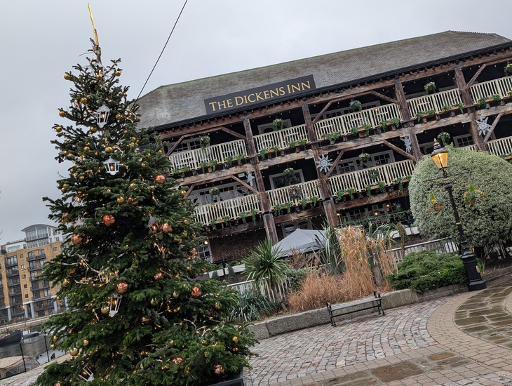 A tree outside a galleried pub