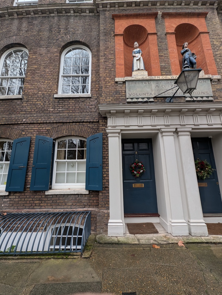 Two stores with statues of children above it