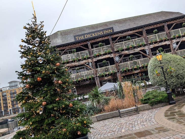 The Dickens Inn with a Christmas tree outside it