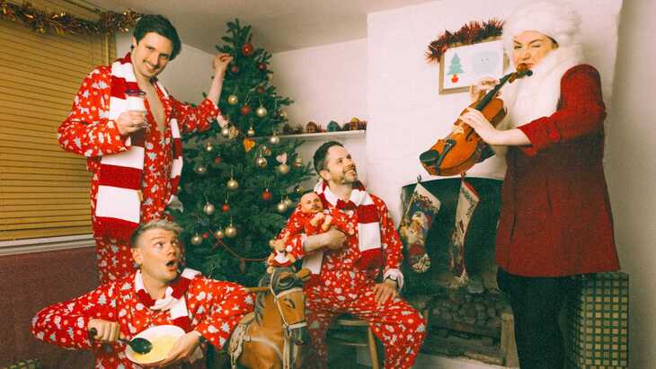 Sheeps in their pyjamas by a Christmas tree