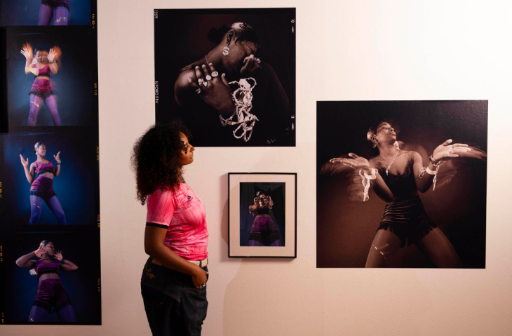 What's on in London in January 2026: a woman looking at photographs on a gallery wall