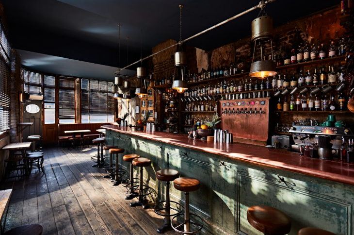 Where to celebrate Burns Night 2026 in London: the interior of the Sun Tavern, with many bottles lining the walls behind the bar
