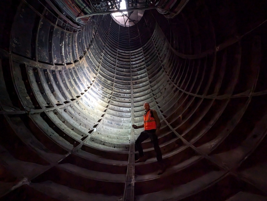A man in a tunnel with a torch