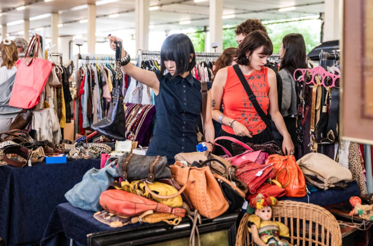 What's on in London this week: two people rummaging through a pile of handbags for sale at the Giant London Flea