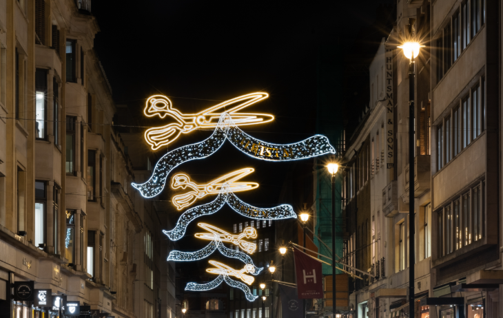 London Christmas lights 2025: Christmas lights shaped like shears and fabric above Savile Row