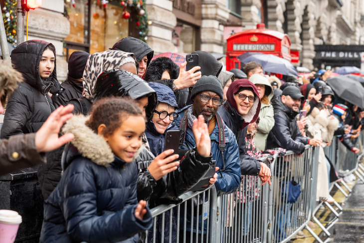 London New Year's Day Parade 2026:  crowds behind a barrier on the pavement watching the parade
