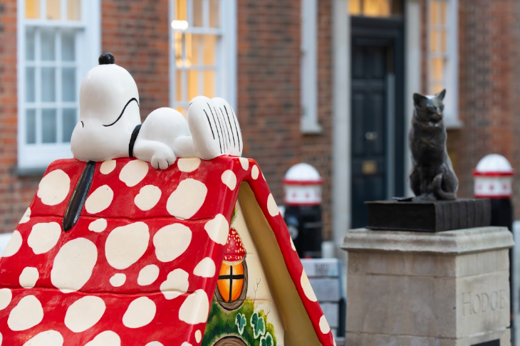 Snoopy in the City sculpture trail: Snoopy lying on top of a kennel with a red and white roof, like a toadstool