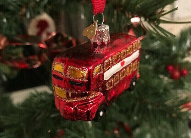 Free travel in London on New Year's Eve: A bus ornament hanging on a Christmas tree