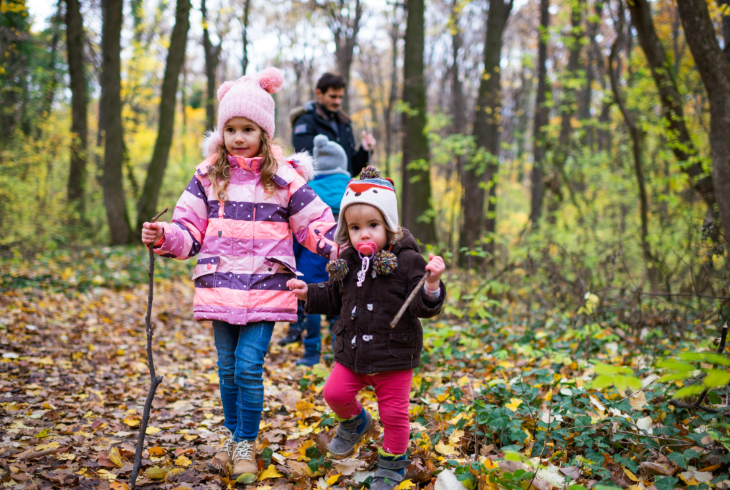 Things to do in London in winter 2026: children dressed for winter walking through a forest