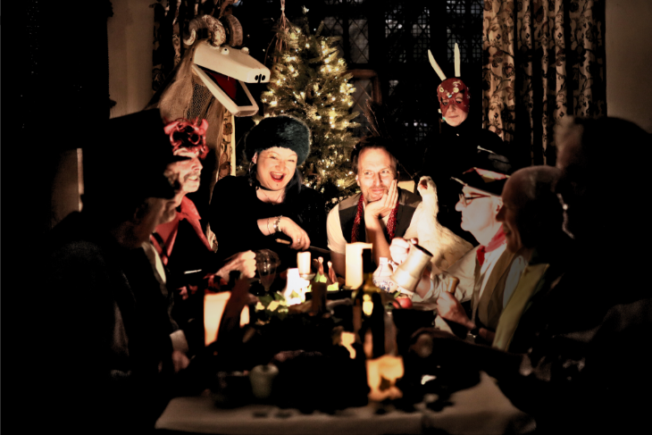 What's on in London today: people gathered around a table by candlelight