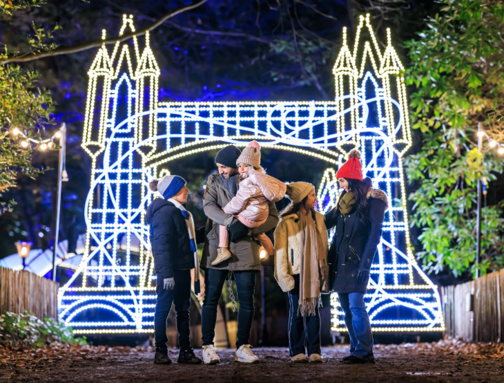 Things to do in London today: a family in front of an illuminated model of Tower Bridge