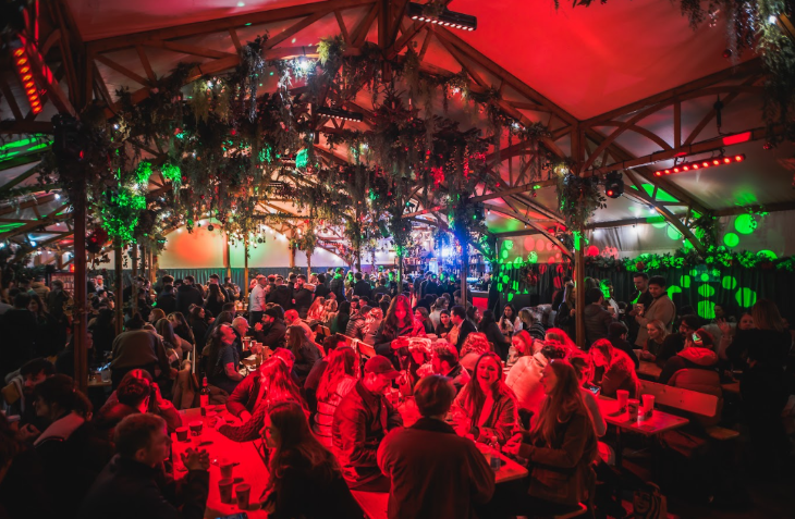 A bar inside a marquee decorated for Christmas