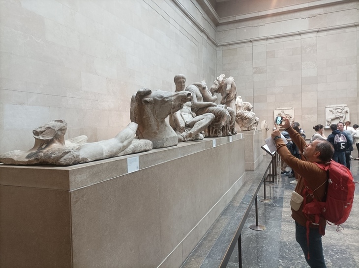 Free museums in London: A person taking snaps of the Elgin Marbles