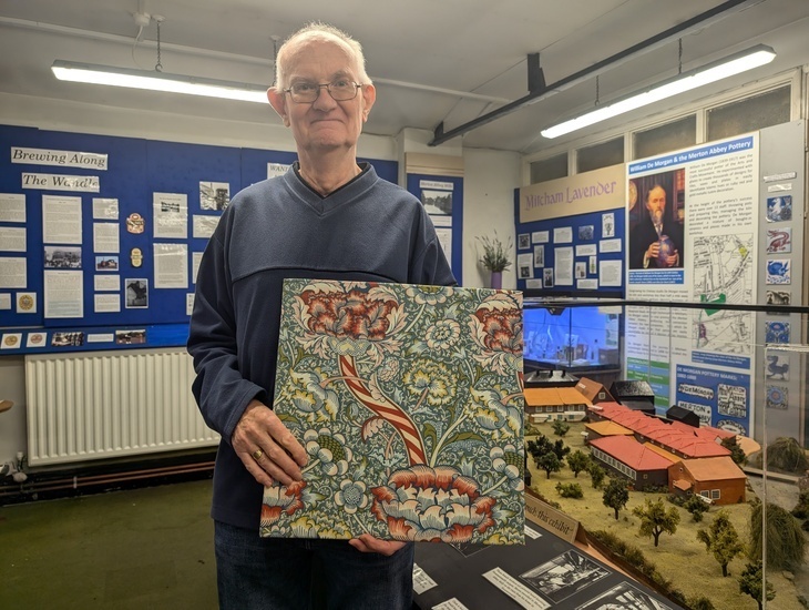 Free museums in London: A man holding a William Morris print