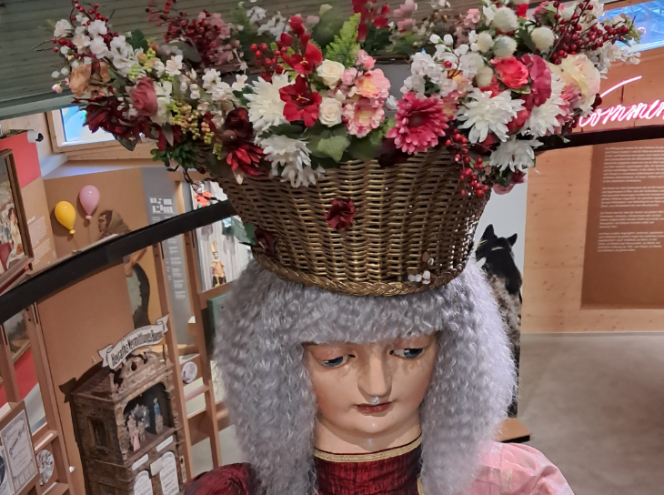 Tips for visiting Vienna:  a large-scale mannequin of a woman, with a basket of flowers on her head