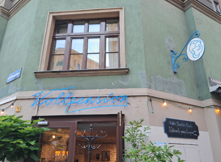 Tips for visiting Vienna:  the exterior of Vollpension, a green-painted venue with the restaurant sign