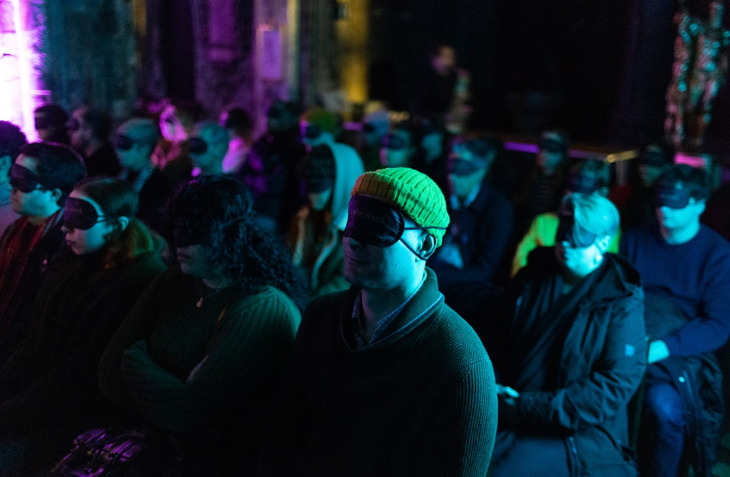 Things to do in London today: people sitting on chairs in rows, blindfolded