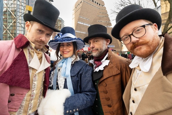 People in victorian smart dress on bankside