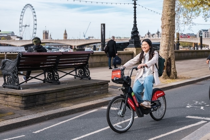 A woman cycling on the embankment in london