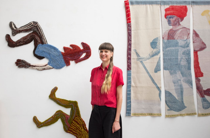 Free events in London this week:  a woman standing in front of textile artists on a wall
