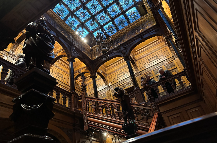 What's on in London today: the hall of a building with dark wood panelled interiors and a stained glass ceiling