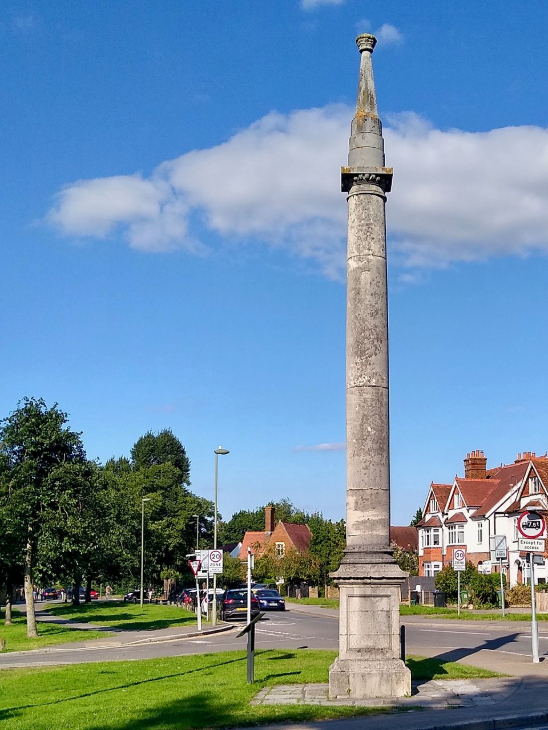 A tall stone column on a village green