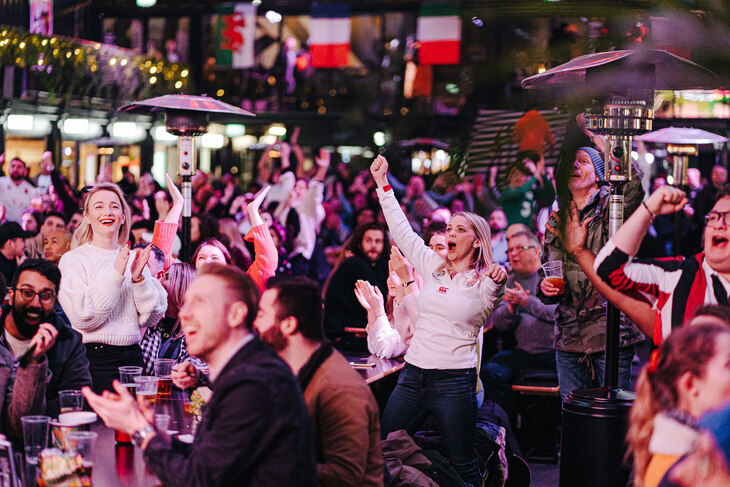 Celebrating audience cheering success at 6 nations in a bar