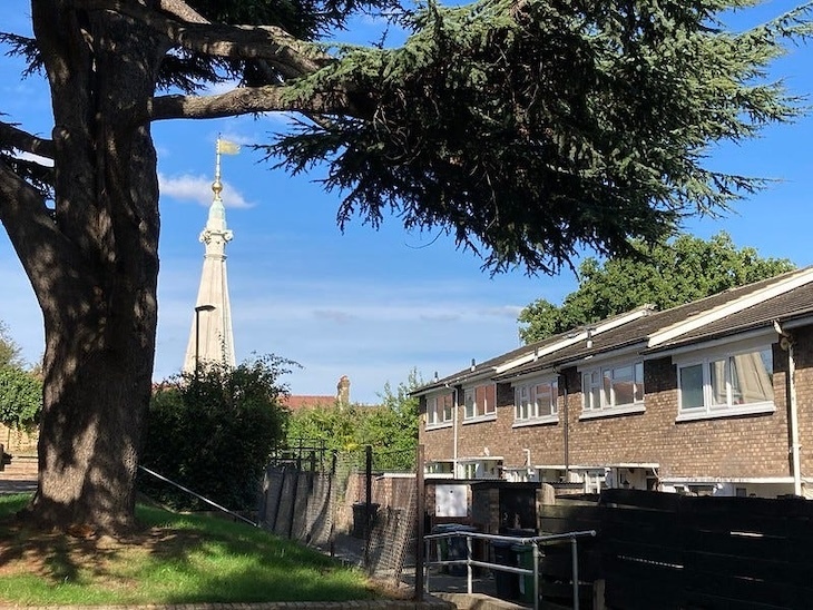 The spire of St Antholins on a housing estate in Forest Hill