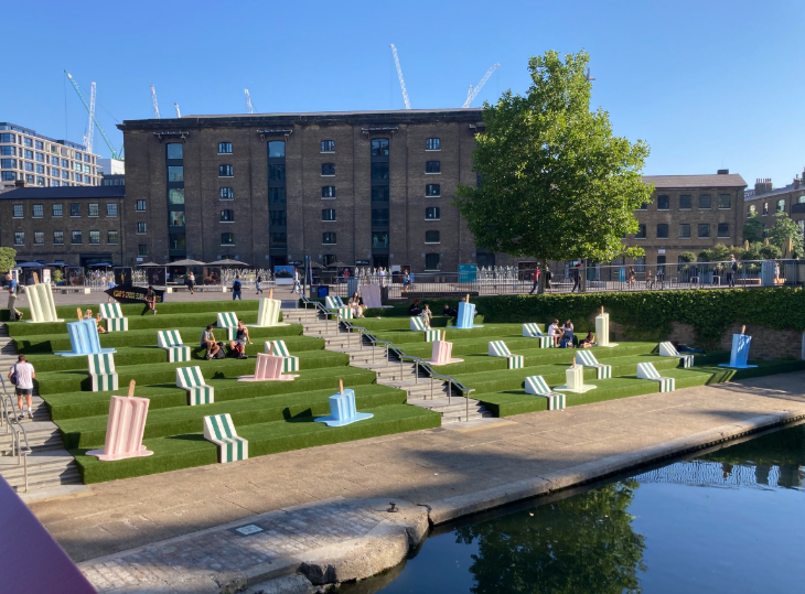 What's on in London Summer 2026: people sitting on grass steps alongside the King's Cross canal in the sunshine