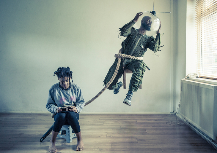 What's on in London today: a girl perched on a stall with an astronaut tied to her by a rope around her waist